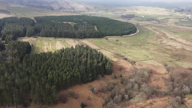 Aerial Drone View Forest Hike In Peak District West Yorkshire Holmfirth Yateholme With Walking trail and Misty Hills In Background