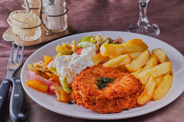 Fish cake with chips and salad.