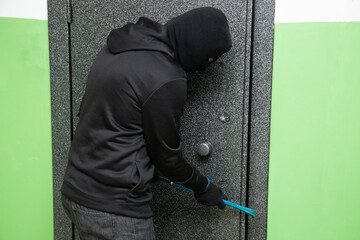 Apartment theft.The thief tries to break into the apartment and steal things.