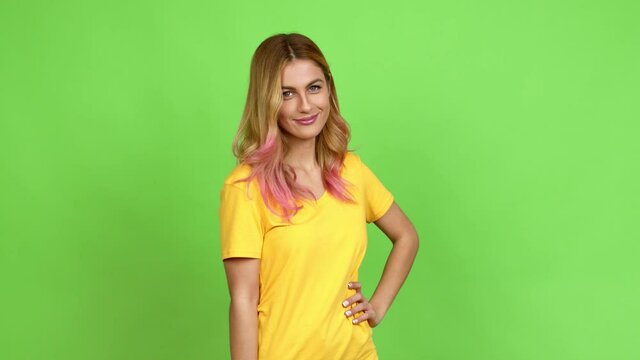 Young blonde woman with happy face over isolated background on green screen chroma key