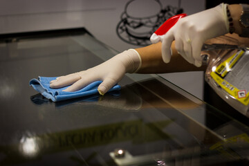 Cleaning and Disinfecting hand on glass