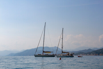 Fototapeta premium Yachts in the sea against the backdrop of mountains and the city.