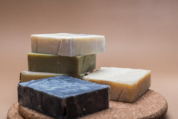 set of handmade soaps, soaps forming a tower on a cork surface and a light background