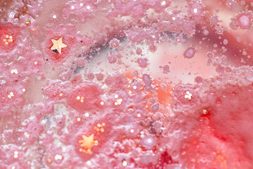 abstract background with golden glitter and liquid crystal effect. Red hot background, wax and water