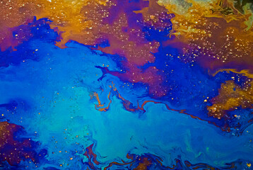 an abstraction of a mixture of bright blue, yellow, crimson and other colors. Mixed paint colors