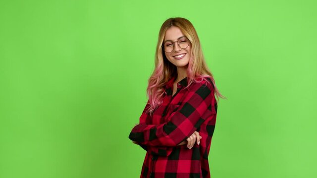 Young blonde woman with glasses over isolated background on green screen chroma key