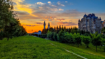 Fototapeta na wymiar Sunrise over the river in Kazan, Kremlin Embankment, Irek Mosque, Russia