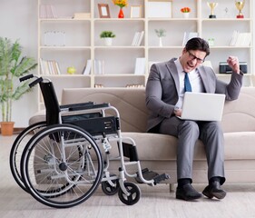 Dsabled businessman on wheelchair working home