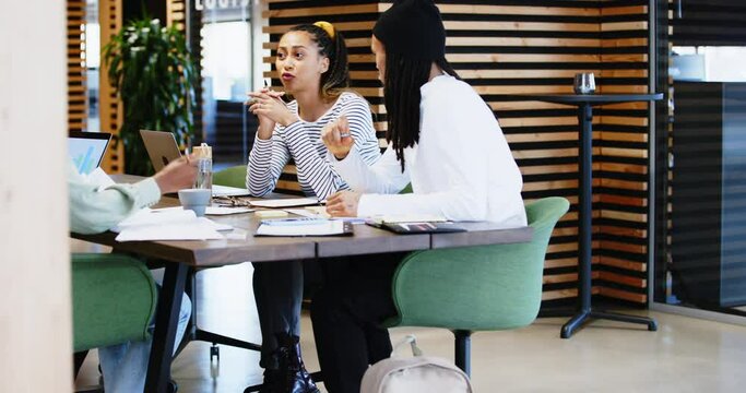 Young businesspeople working at a
table in a modern office
