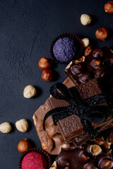 Chocolate bar, crushed pieces of dark chocolate and nuts. Praline Chocolate sweets