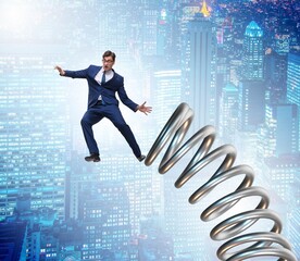 Businessman jumping from spring in promotion concept