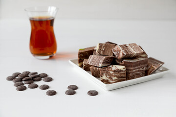 Halva with tea in a Turkish glass and chocolate biscuits