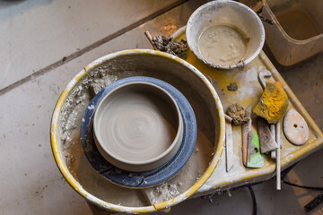 Pottery wheel with ceramics tools for making art and craft objects from clay in a workshop studio