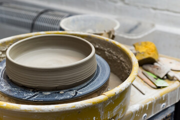 Pottery wheel with ceramics tools for making art and craft objects from clay in a workshop studio