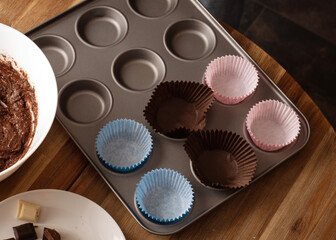 cupcake dough, chocolate and cupcake mold on the table in kitchen 
