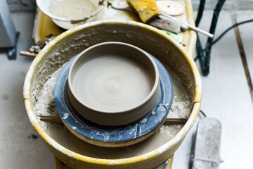 Pottery wheel with ceramics tools for making art and craft objects from clay in a workshop studio