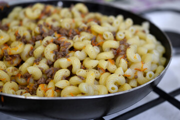 Navy pasta with meat in a saucepan