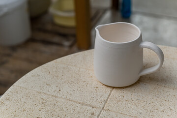 Collection of finished ceramics products made from clay by hand displayed on a kiln used in the...