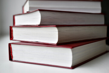Red bound books on a white background
