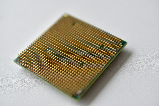 Computer processor with contact legs on a white background