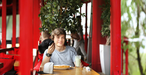 Lifestyle portrait of a young man using a smart phone outdoors