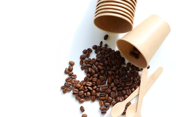 Obraz premium Flat lay composition with coffee beans, kraft paper cup and wooden spoon. Top view, copy space