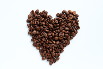 Heart shaped coffee beans on white table background. Top view, copy space