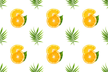 Fresh orange fruit slices with green palm leaf on white background. Seamless pattern with fruits, tropical or summertime concept. Top view, flat lay.