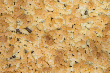 A topping of an apple crumble. Top view of an apple pie texture 