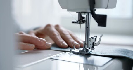 Close-up of a sewing machine needle in motion in 4k . Manufacturing from leather products. The work of a seamstress.