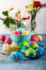 Colorful easter eggs on a blue wooden table. 