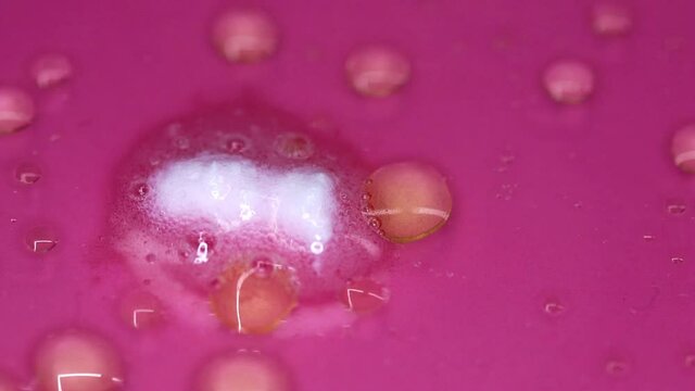 Effervescent effect with bubbles in colored liquid. Corrosive chemical reaction. Simulation of acid reaction in a liquid