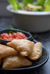 Samosa is a fried or baked pastry with a savory filling, such as spiced potatoes, onions, peas, cheese, beef and other meats