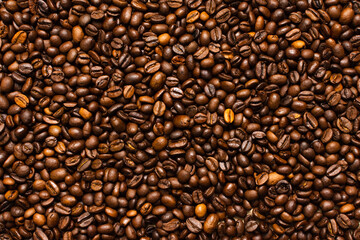 Coffee beans. Coffee beans are spread out on the surface.