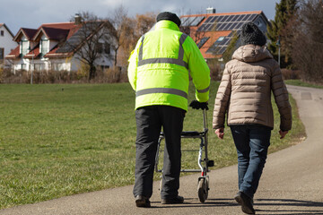 senior man and woman with rollator