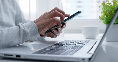 Woman's hands use mobile phone and laptop to shop online. Authentication in Internet banking on a smartphone and computer. Slow motion 4k. - Powered by Adobe