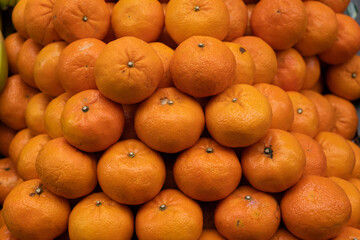 Group of colorful juicy tangerines in a food market