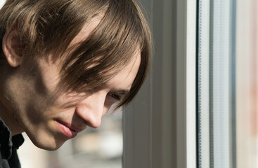 Portrait image of a young guy near the window