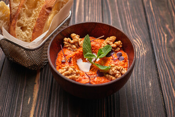 Muhammara, Eastern snack on a dark wooden board