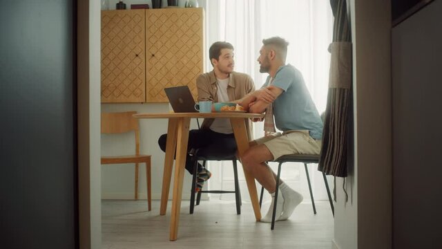 Happy Gay Couple Eat Healthy Breakfast Meal and Use Laptop