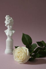 white rose and small sculpture