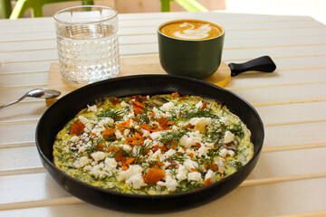 Close up of breakfast with omelette and coffee during a sunny day