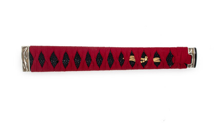 Handle of samurai katana japanese sword. Handmade tsuka with red wicker ornament isolated on a white background.