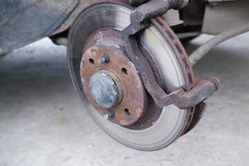 Car repair. Replacing the brake pads of disc brakes. Brake disc close-up.