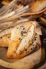Fresh bread rolls on a rustic wooden table.