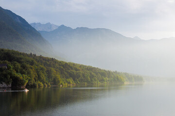 Fototapeta na wymiar Morning fog on lake Bohinj, Slovenia. Defocused