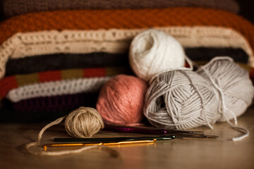 Fototapeta na wymiar Knitted things. Tangles, knitting needles, and a hook.