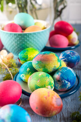 Fototapeta na wymiar Colorful easter eggs on a blue wooden table. 