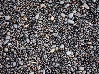 Gray pebbles as a background in the Iceland sea shore. Abstract composition. Design image.