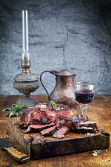 Traditional dry aged barbecue wagyu porterhouse beef steak sliced with herbs and salt served as...